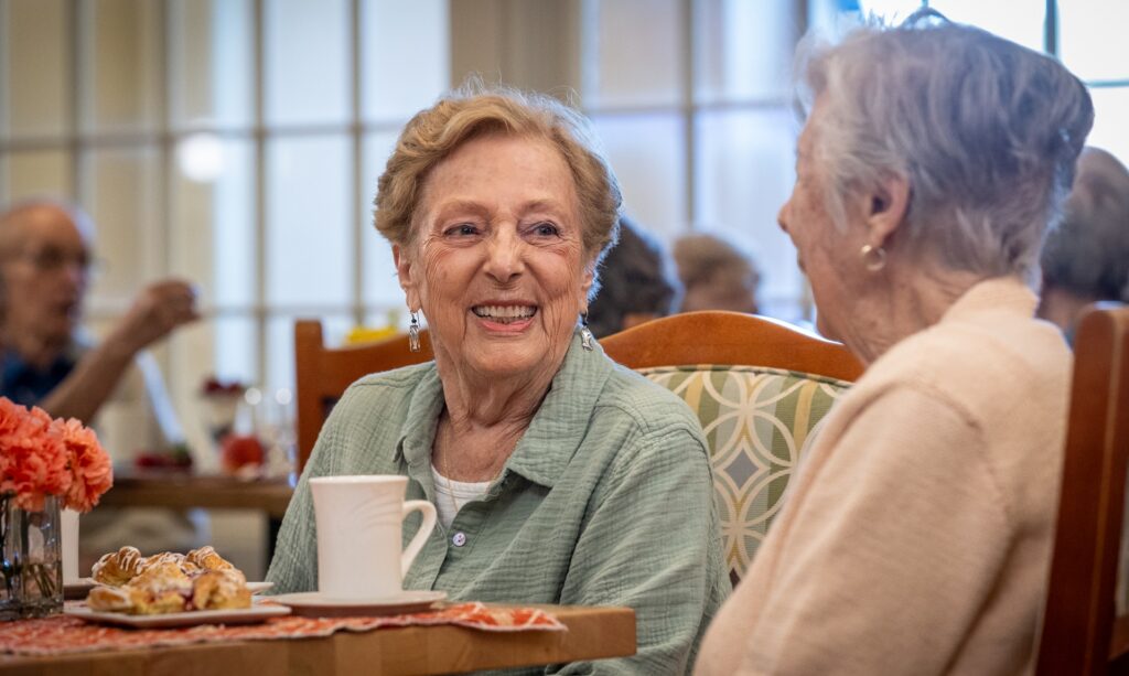 happy elderly women smiling while having lunch - east hill