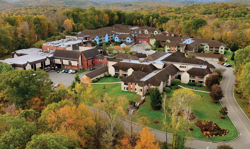 Aerial view of the East Hill campus in Southbury surrounded by fall foliage